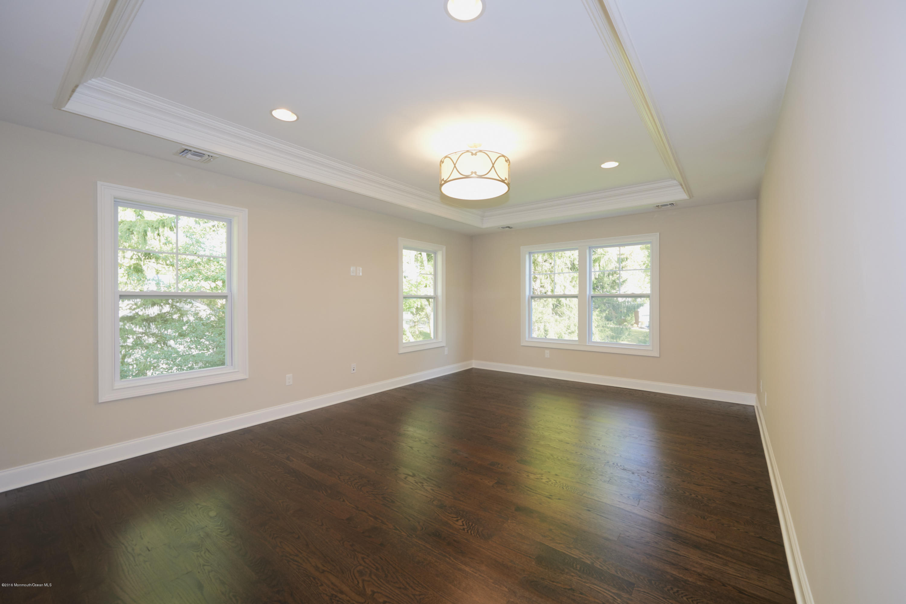 17 Cardinal Road Middletown, NJ 07748 - Photo 14 of 22 an empty room with wooden floor and windows