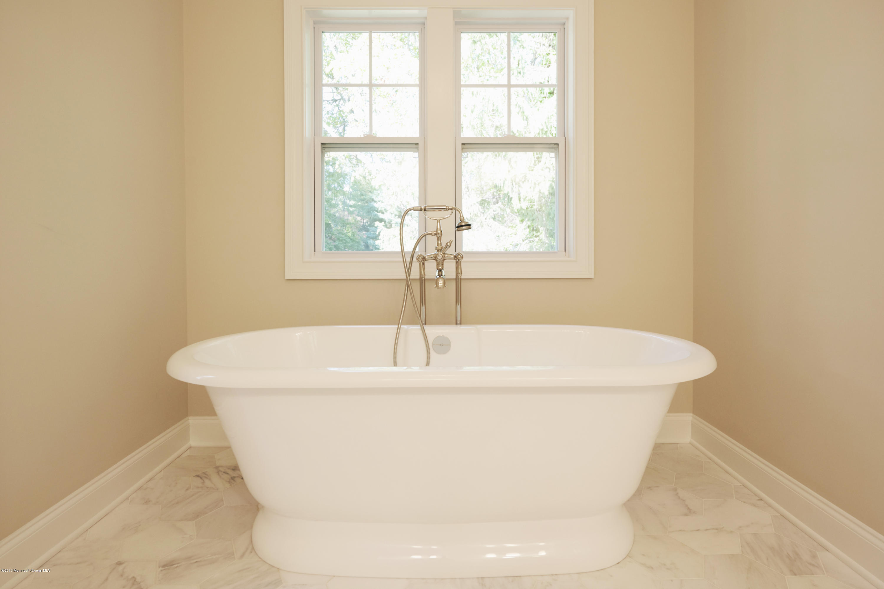 17 Cardinal Road Middletown, NJ 07748 - Photo 16 of 22 a white bath tub sitting in a bathroom