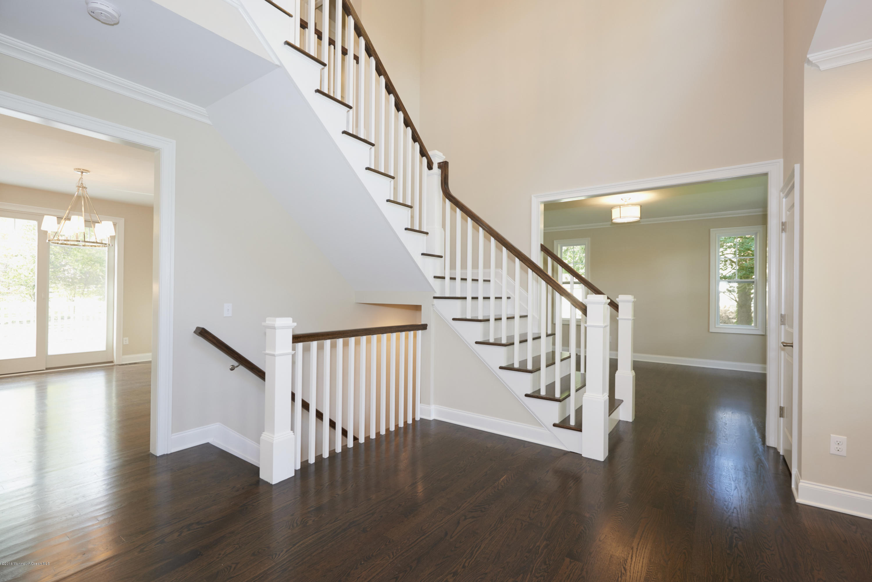 17 Cardinal Road Middletown, NJ 07748 - Photo 4 of 22 a view of staircase with wooden floor and a front door