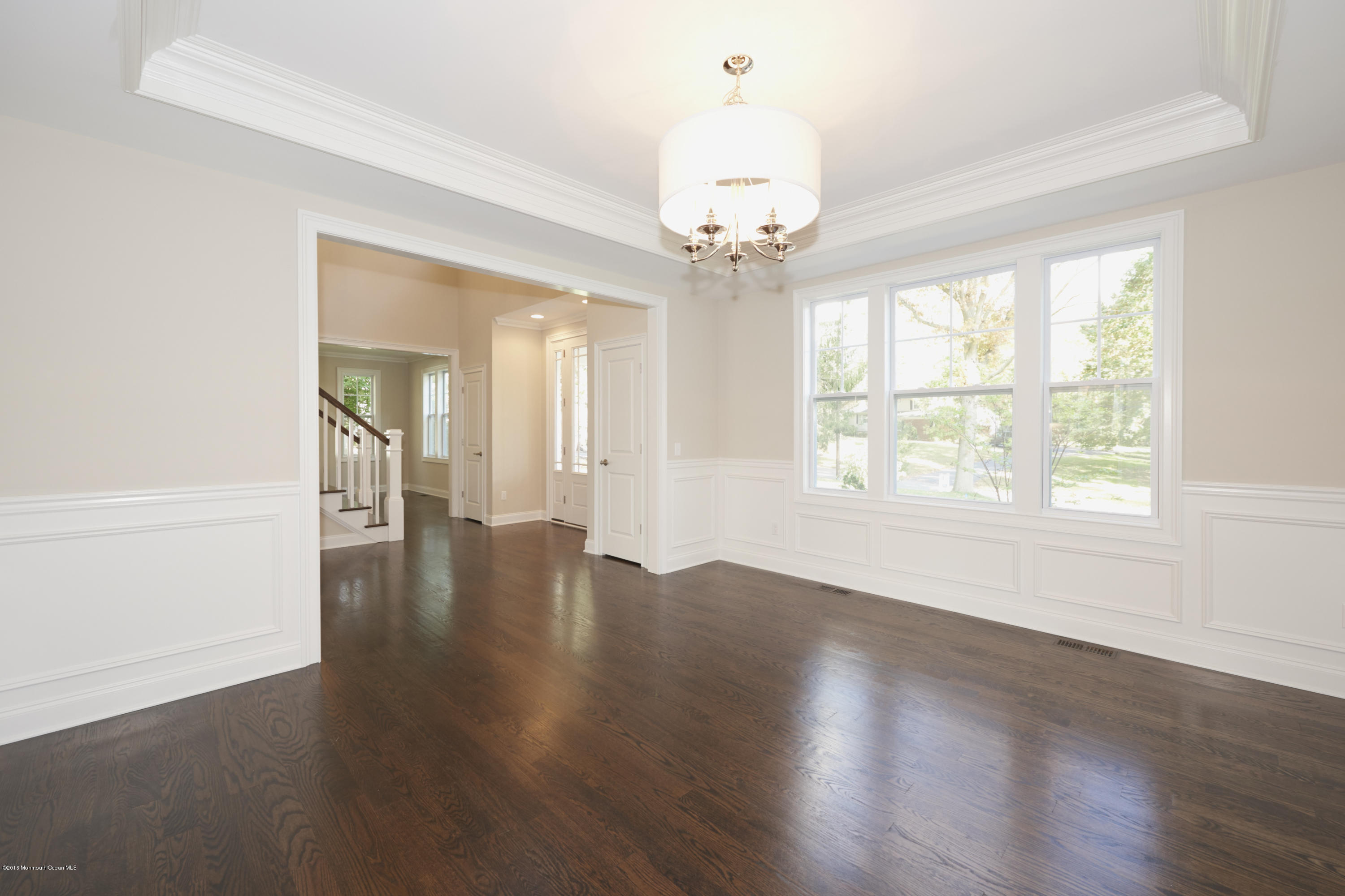 17 Cardinal Road Middletown, NJ 07748 - Photo 6 of 22 an empty room with wooden floor and windows