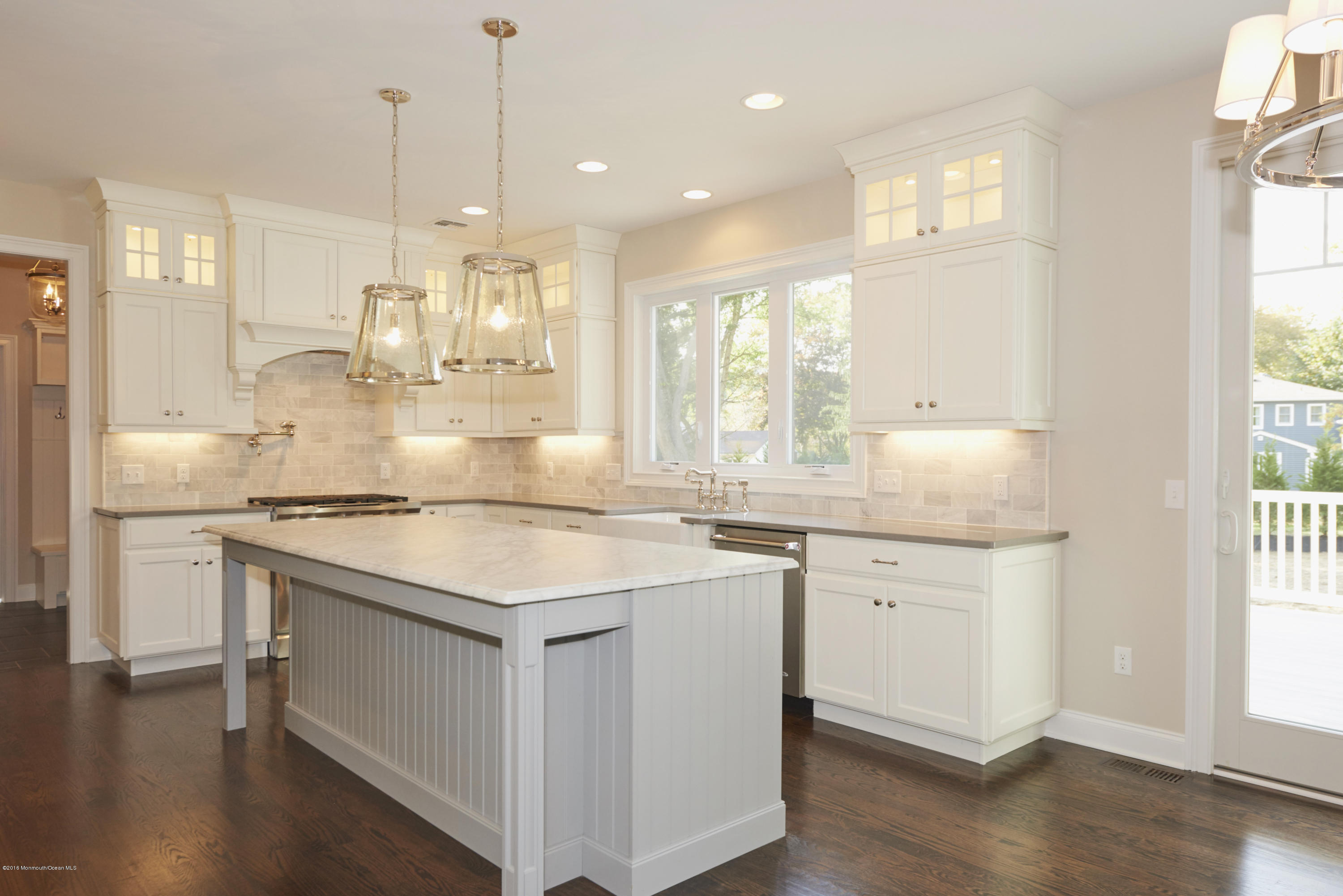 17 Cardinal Road Middletown, NJ 07748 - Photo 8 of 22 a kitchen with a stove a sink a center island and wooden floor