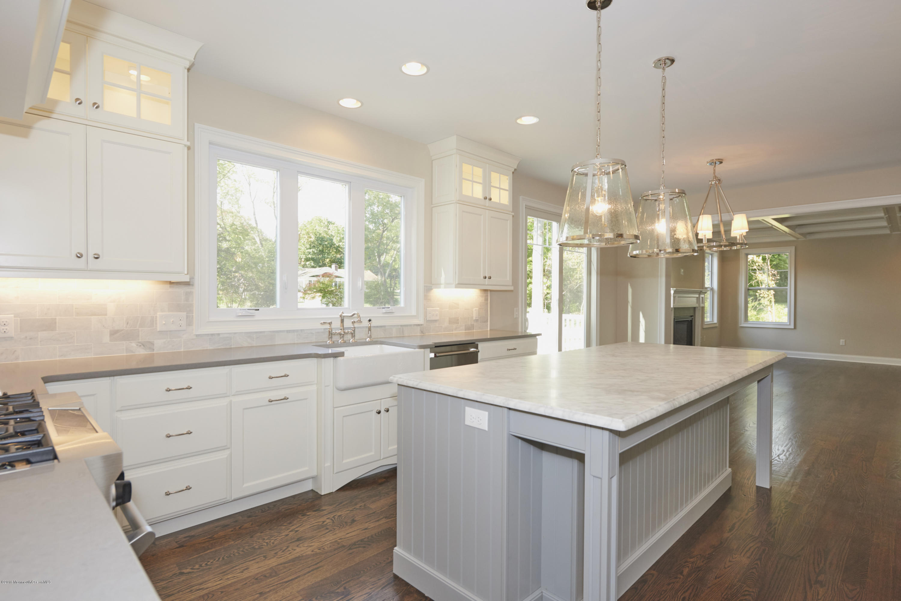 17 Cardinal Road Middletown, NJ 07748 - Photo 10 of 22 a kitchen with a sink chandelier and living room view