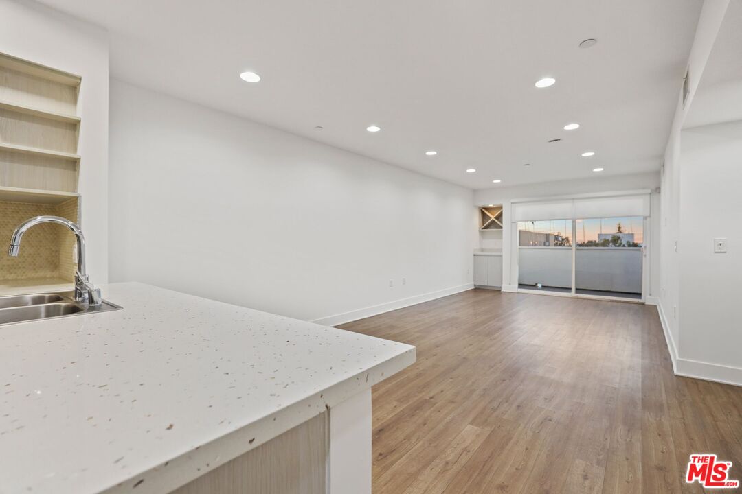1539 Beloit Avenue, Unit PH19 Los Angeles, CA 90025 - Photo 5 of 13 a view of kitchen and wooden floor