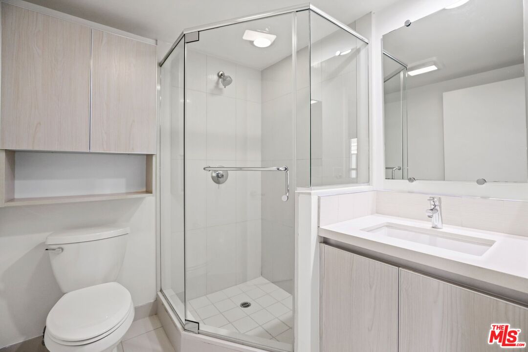 1539 Beloit Avenue, Unit PH19 Los Angeles, CA 90025 - Photo 10 of 13 a bathroom with a sink a toilet and shower
