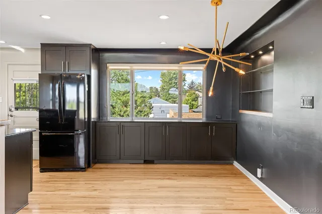 a view of a refrigerator in kitchen and wooden floor