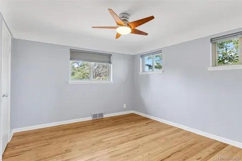 a view of empty room with wooden floor