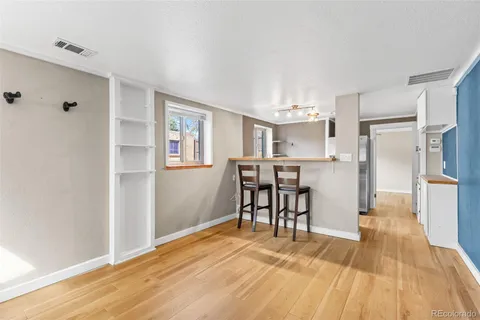 a view of a kitchen with dining space and wooden floor