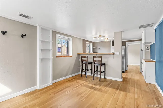 a view of a kitchen with dining space and wooden floor