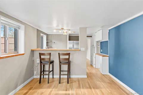 a kitchen with stainless steel appliances a dining table chairs and chandelier