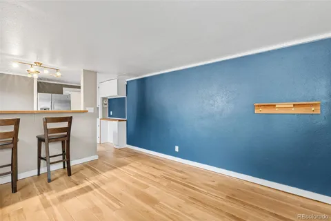 a view of kitchen with stainless steel appliances cabinets and wooden floor