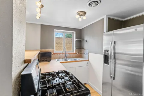 a kitchen with a sink stove and refrigerator
