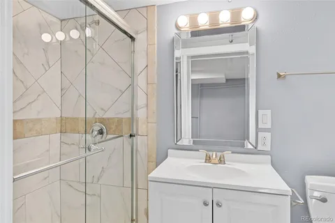 a bathroom with a sink vanity and a mirror