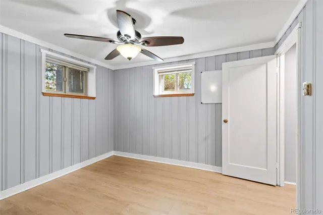a view of empty room with wooden floor