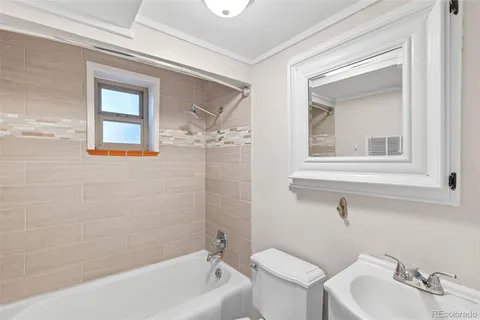 a bathroom with a sink mirror toilet and bathtub