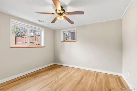 a view of empty room with wooden floor