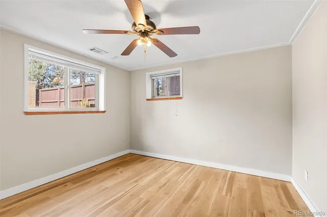 a view of empty room with wooden floor