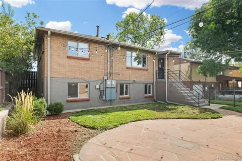 a front view of a house with a yard and a porch