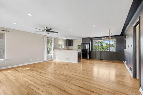a view of kitchen with a sink and dishwasher with wooden floor