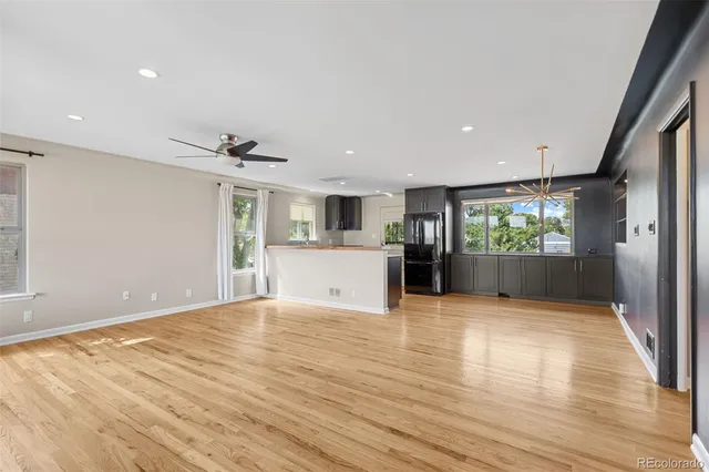 a view of kitchen with a sink and dishwasher with wooden floor