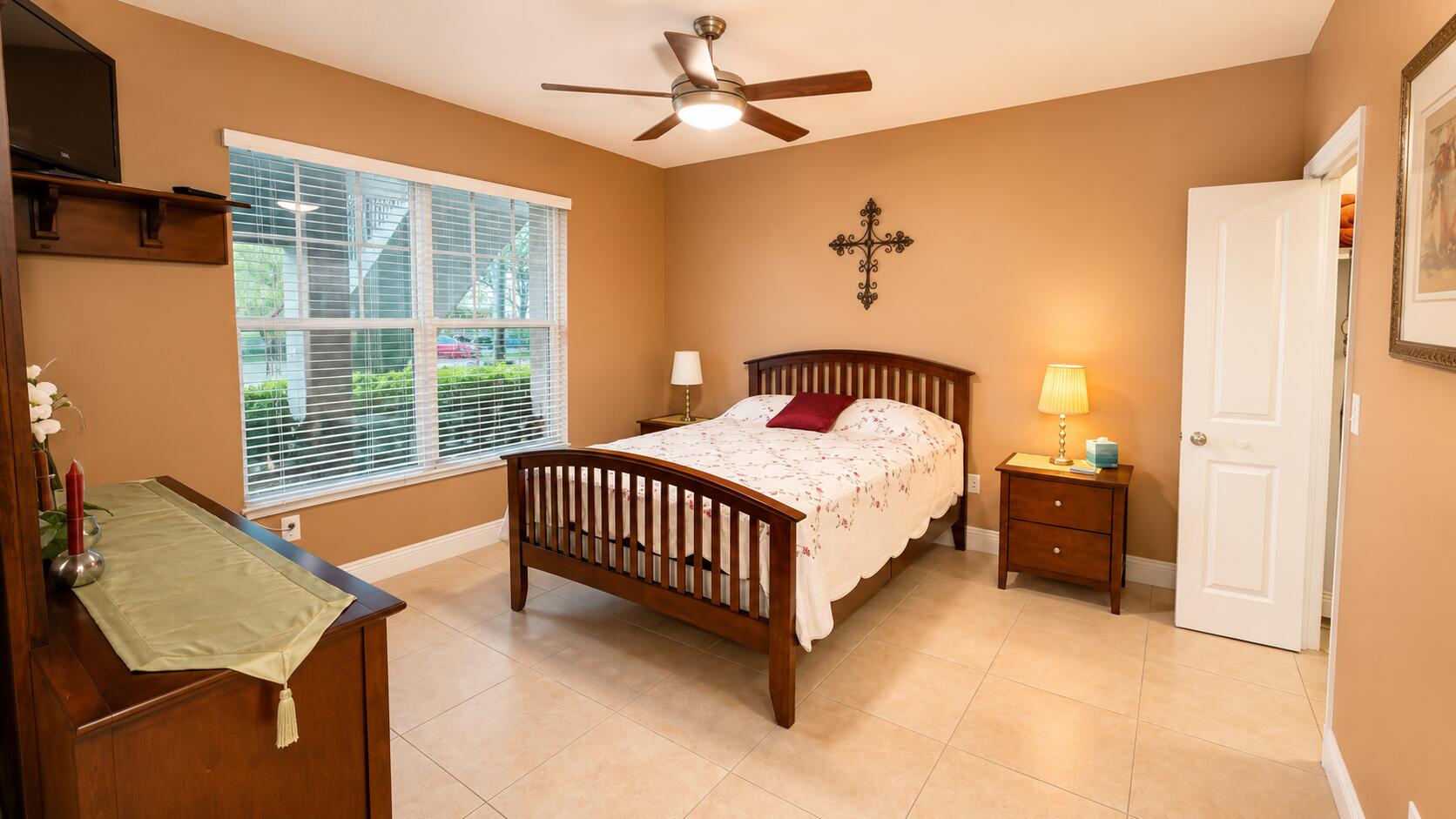5880 West Sample Road, Unit 105 Coral Springs, FL 33067 - Photo 7 of 17 a bed sitting in a bedroom next to a window
