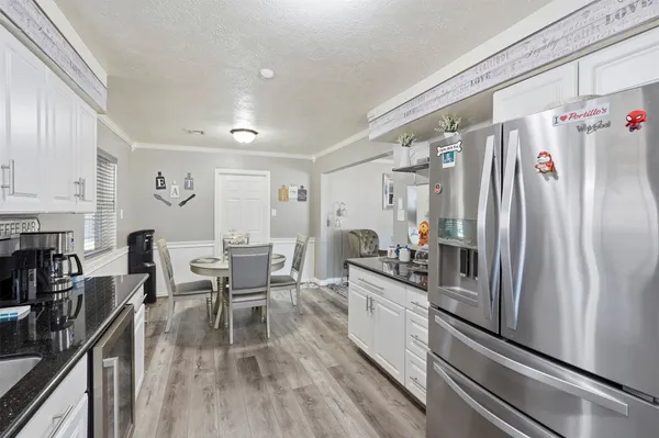 a kitchen with counter top space a sink appliances and cabinets