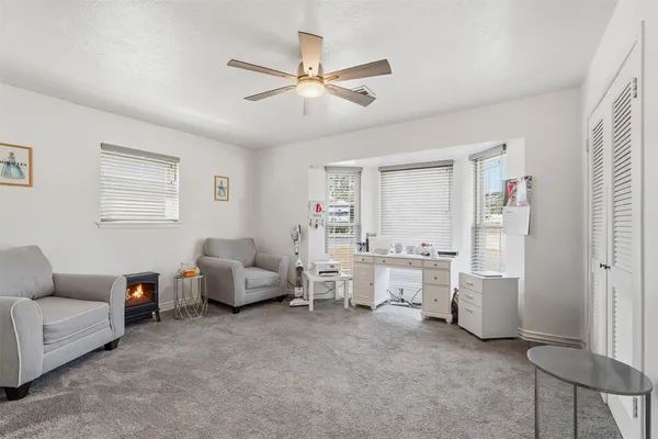 a living room with furniture and white walls