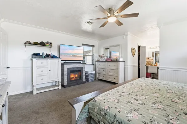 a spacious bedroom with a bed and a fireplace