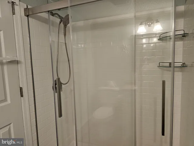 a bathroom with a glass shower door