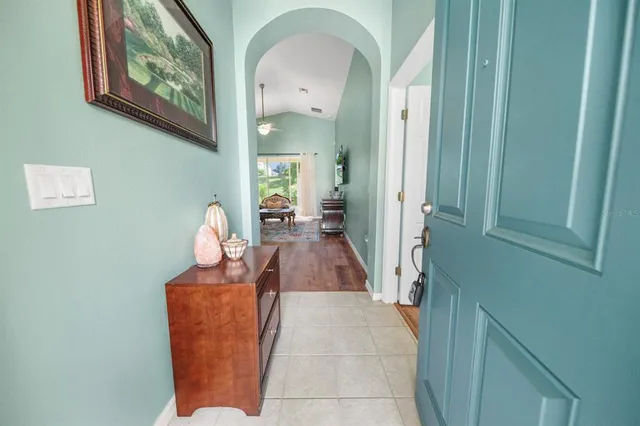 a view of a hallway with entryway wooden floor and front door