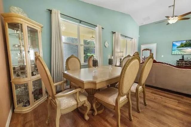 a view of a dining room with furniture window and wooden floor