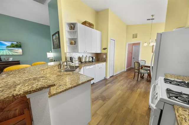 a kitchen with a sink stove and a refrigerator