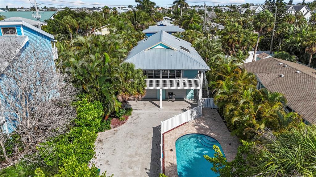 315 Spring Avenue Anna Maria, FL 34216 - Photo 47 of 63 an aerial view of a house with yard swimming pool and outdoor seating