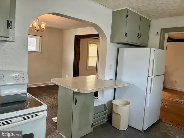 a kitchen with a sink and a refrigerator