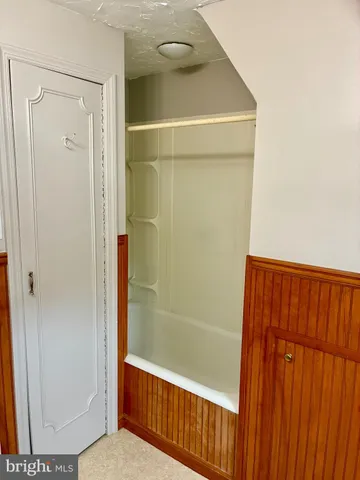 a bathroom with a shower and a door