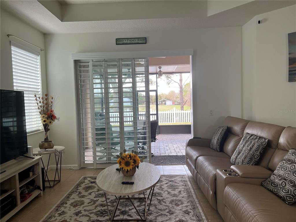 4419 Azure Isle Way Kissimmee, FL 34744 - Photo 14 of 39 a living room with furniture and a flat screen tv