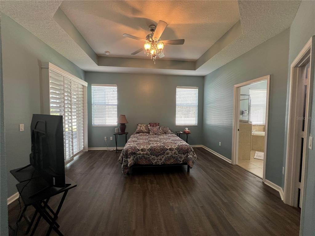 4419 Azure Isle Way Kissimmee, FL 34744 - Photo 17 of 39 a living room with furniture and a chandelier