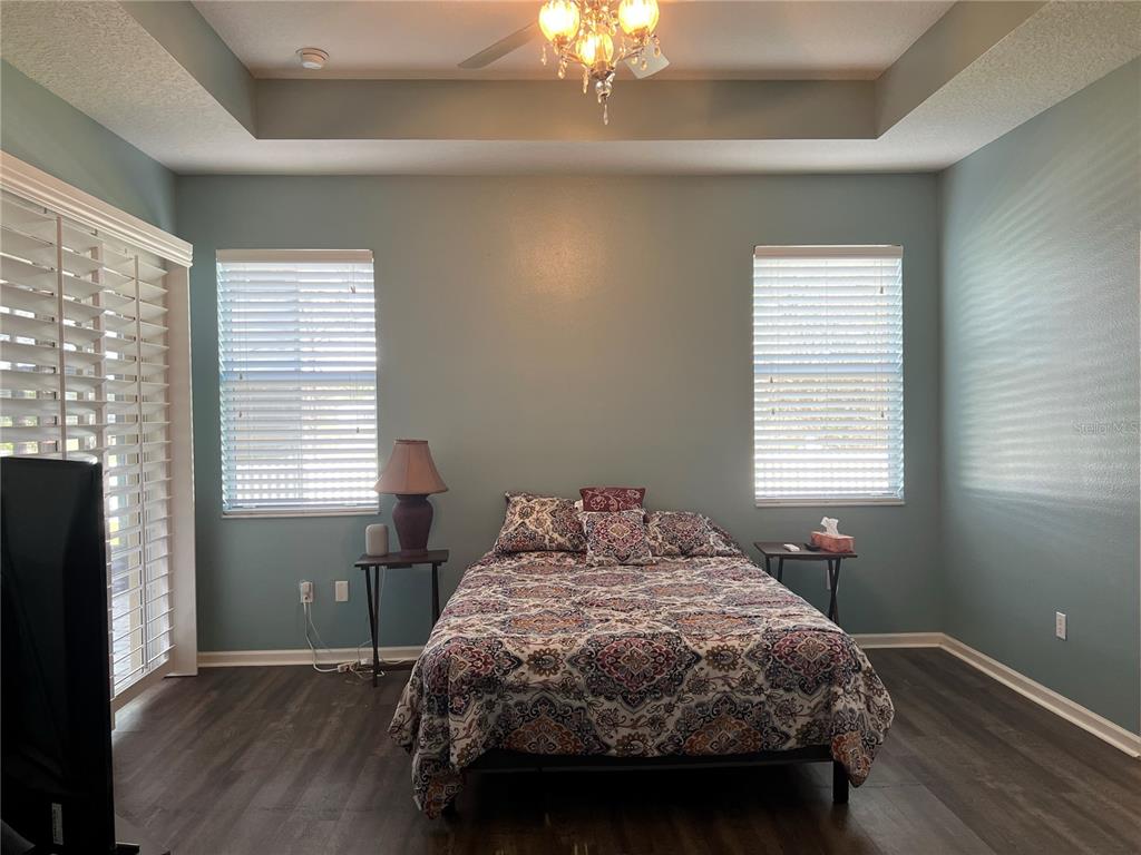 4419 Azure Isle Way Kissimmee, FL 34744 - Photo 18 of 39 a bedroom with a bed and a window