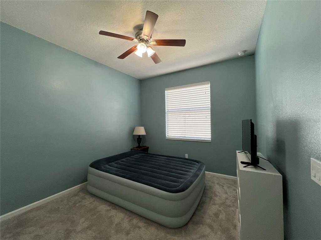 4419 Azure Isle Way Kissimmee, FL 34744 - Photo 23 of 39 a living room with couch and a window