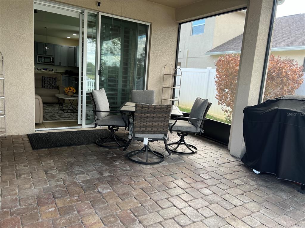 4419 Azure Isle Way Kissimmee, FL 34744 - Photo 28 of 39 a living room with furniture and large windows