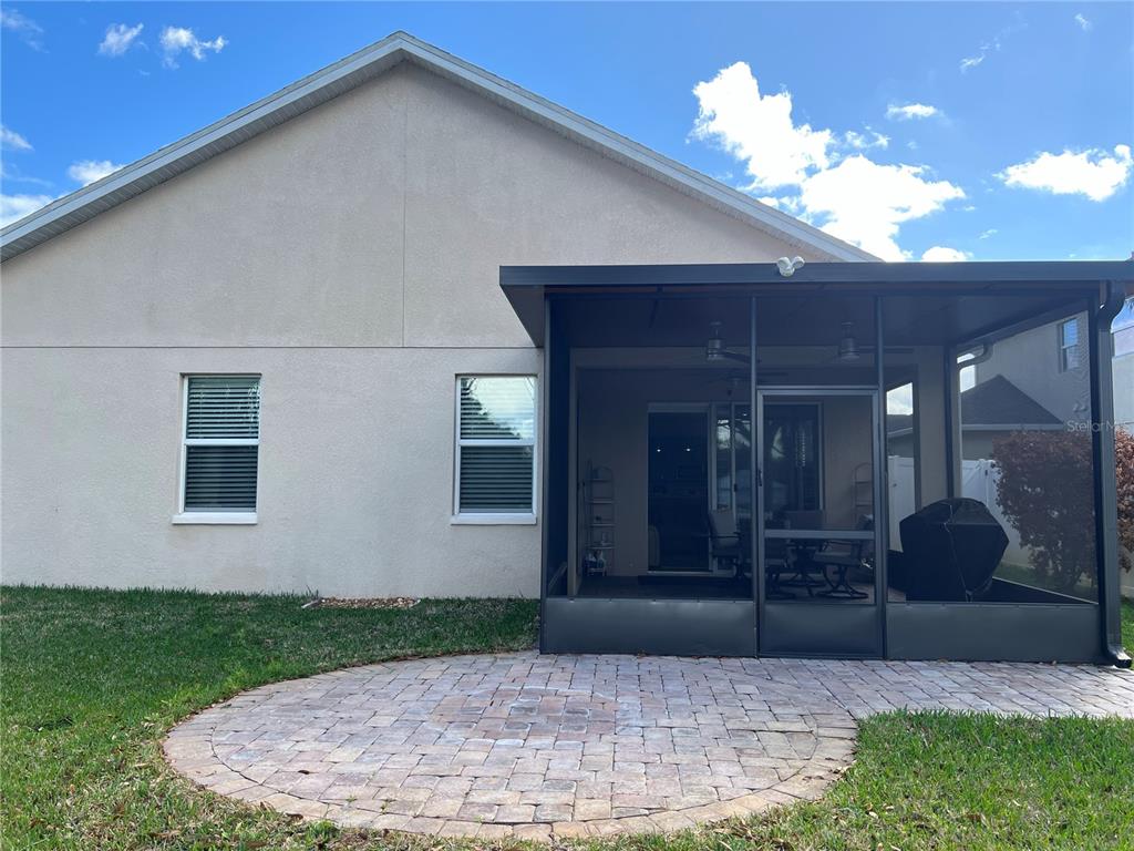 4419 Azure Isle Way Kissimmee, FL 34744 - Photo 29 of 39 a view of a house with a yard and potted plants