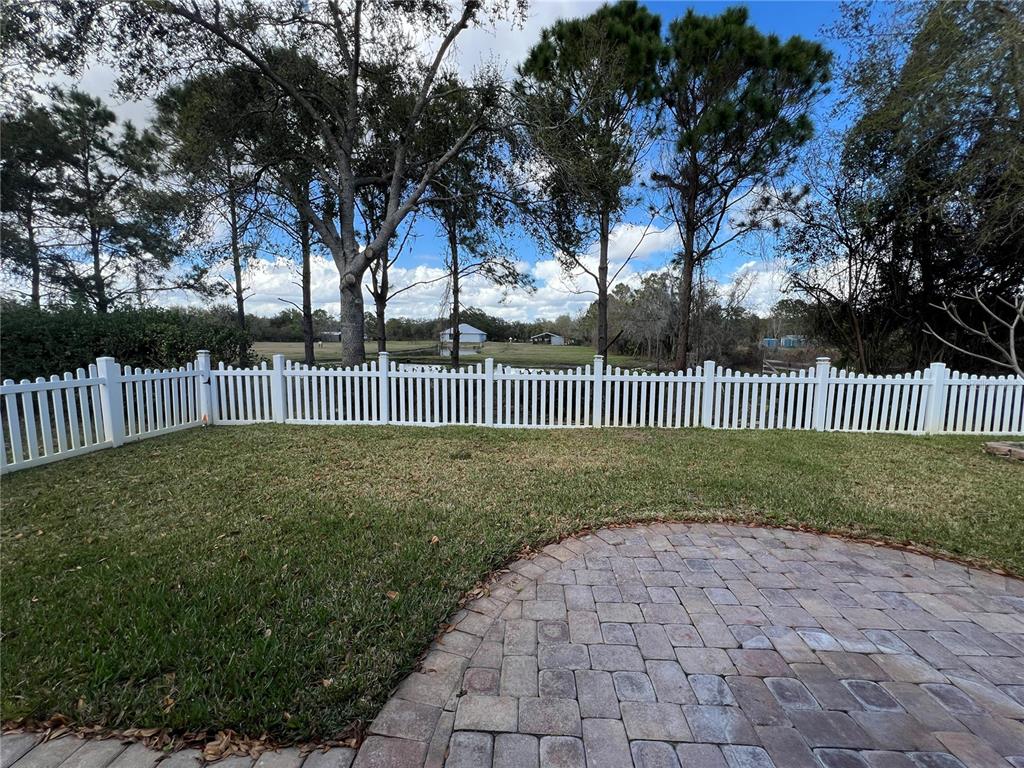 4419 Azure Isle Way Kissimmee, FL 34744 - Photo 31 of 39 a view of a yard with a wooden fence
