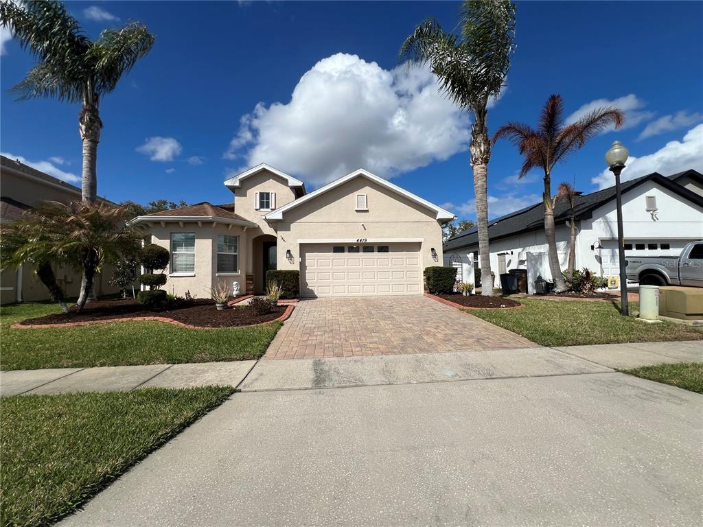 4419 Azure Isle Way Kissimmee, FL 34744 - Photo 4 of 39 a front view of a house with garden