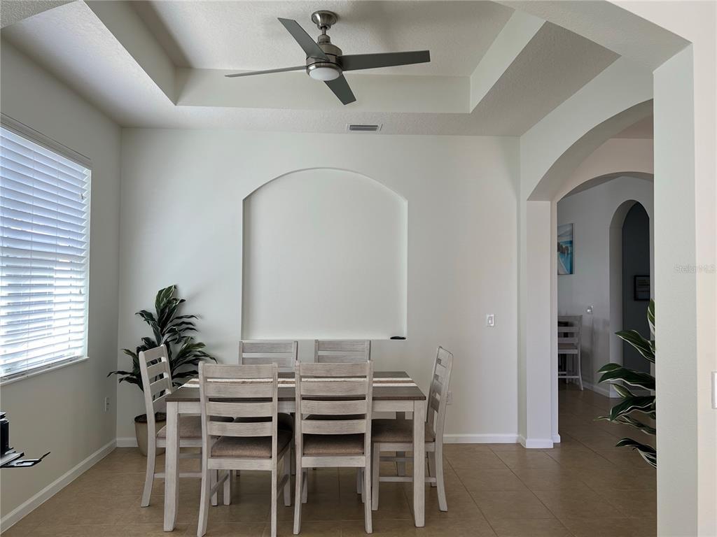 4419 Azure Isle Way Kissimmee, FL 34744 - Photo 5 of 39 a view of a dining room with furniture