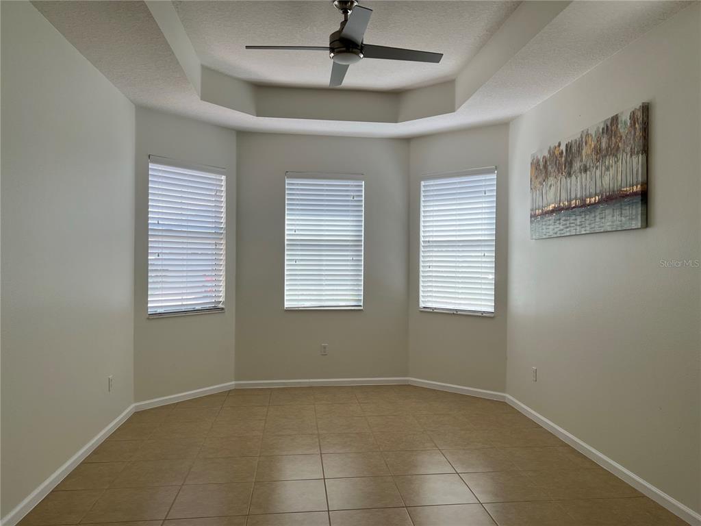 4419 Azure Isle Way Kissimmee, FL 34744 - Photo 6 of 39 a view of an empty room with a window