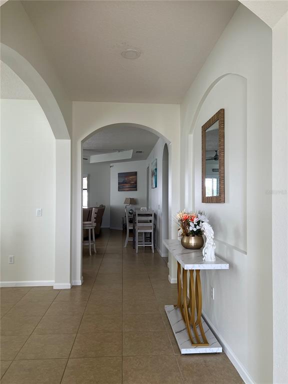4419 Azure Isle Way Kissimmee, FL 34744 - Photo 7 of 39 a living room with furniture and a table