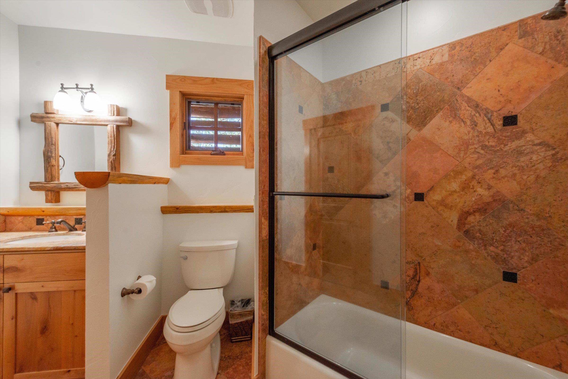 350 Skidder Trail Truckee, CA 96161 - Photo 11 of 20 a bathroom with a granite countertop toilet sink and shower