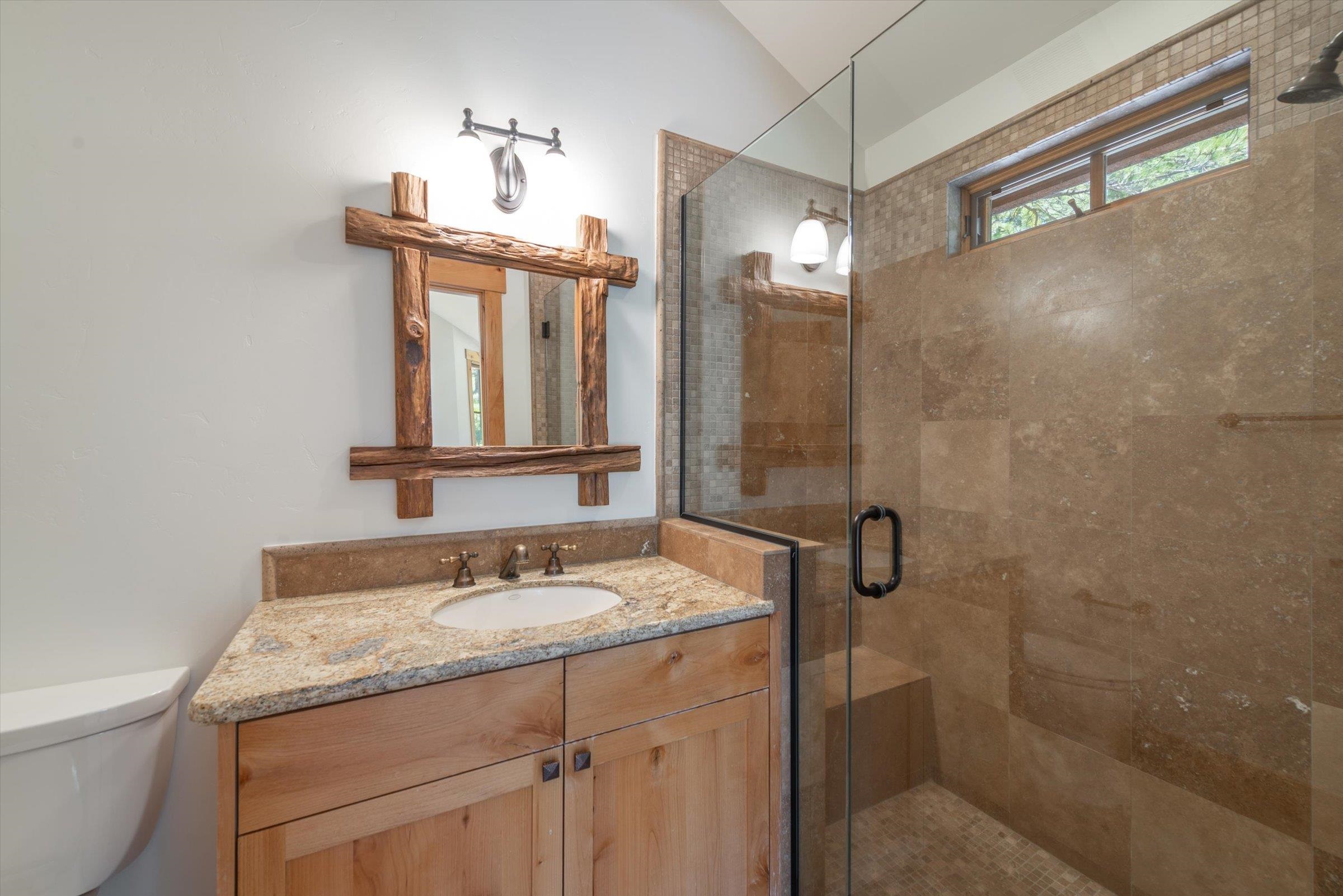 350 Skidder Trail Truckee, CA 96161 - Photo 20 of 20 a bathroom with a granite countertop sink a toilet and shower