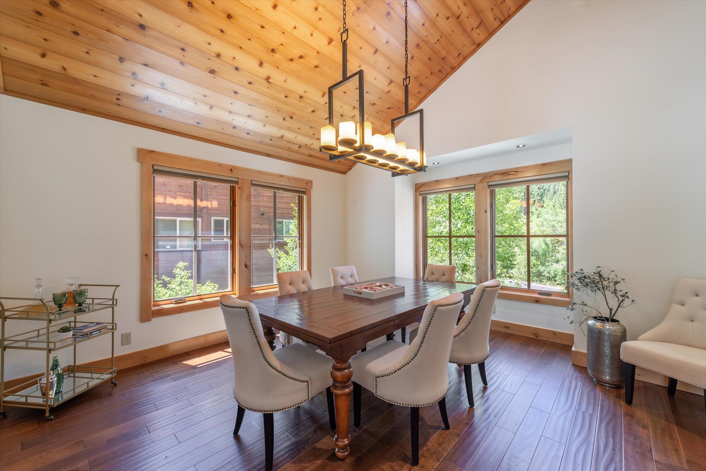 350 Skidder Trail Truckee, CA 96161 - Photo 3 of 20 a dining room with wooden floor a chandelier a wooden table and chairs