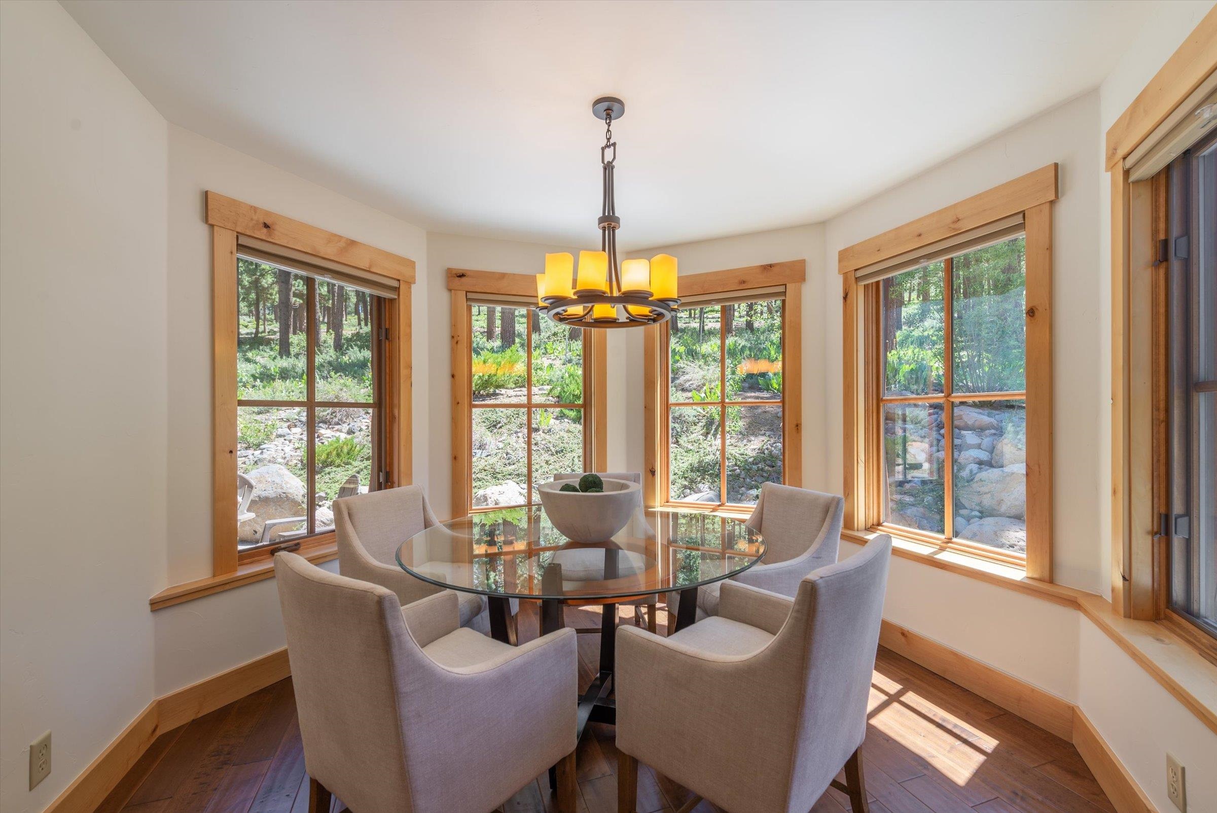 350 Skidder Trail Truckee, CA 96161 - Photo 5 of 20 a dining room with furniture large windows and wooden floor