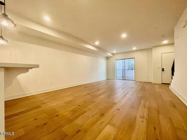 a view of a room with wooden floor
